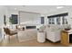 Open-concept living room with a fireplace and modern decor, offering a bright and spacious living area at 1542 Bayshore Blvd, Dunedin, FL 34698