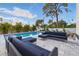 Backyard pool with lounge seating and tropical landscaping at 1542 Bayshore Blvd, Dunedin, FL 34698
