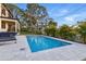 A beautiful swimming pool with patio surrounded by green plants, ideal for leisure and entertainment at 1542 Bayshore Blvd, Dunedin, FL 34698