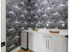 Stylish powder room featuring unique wallpaper, white cabinetry, and sleek fixtures at 1542 Bayshore Blvd, Dunedin, FL 34698