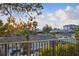 Balcony view showcasing neighborhood and distant ocean views through the trees at 1542 Bayshore Blvd, Dunedin, FL 34698