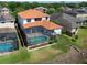Aerial view of a beautiful property showcasing a sparkling swimming pool within a screened enclosure at 15630 N Himes Ave, Tampa, FL 33618
