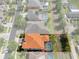 An aerial view of the residence highlighting property lines, orange roof, screened pool, and backyard at 15630 N Himes Ave, Tampa, FL 33618