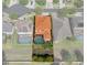 Aerial view of the house with property lines, orange roof, a screened pool and neighboring houses at 15630 N Himes Ave, Tampa, FL 33618