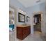 Bright bathroom with a sleek vanity, modern lighting, and seamless access to the bedroom and walk-in closet at 15630 N Himes Ave, Tampa, FL 33618