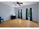 Light and airy bedroom with wood floors, ceiling fan, and dark teal curtains at 15630 N Himes Ave, Tampa, FL 33618