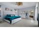 Bright bedroom with a luxurious bed, modern ceiling fan, and ensuite bathroom access for ultimate relaxation at 15630 N Himes Ave, Tampa, FL 33618