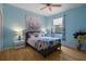 Bright bedroom features stylish accents and a colorful comforter on a queen bed at 15630 N Himes Ave, Tampa, FL 33618