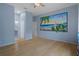 Bedroom with wood floors, blue accent wall featuring a mural, and ensuite bathroom at 15630 N Himes Ave, Tampa, FL 33618
