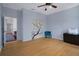Bedroom with wood floors, blue chair, and closet with painted cherry blossom design at 15630 N Himes Ave, Tampa, FL 33618