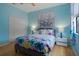 Bright bedroom features stylish accents, a colorful comforter on a queen bed and a large closet at 15630 N Himes Ave, Tampa, FL 33618