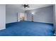 View of a bright and spacious bonus room featuring blue carpet and grey paint at 15630 N Himes Ave, Tampa, FL 33618