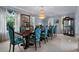 Elegant dining room with decorative chairs, dark wood table, and chandelier at 15630 N Himes Ave, Tampa, FL 33618