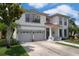 Lovely two-story home with a well-kept lawn, two-car garage, and elegant plants at 15630 N Himes Ave, Tampa, FL 33618
