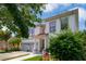 Charming two-story house with a two-car garage, beautiful plants, and a stone walkway at 15630 N Himes Ave, Tampa, FL 33618