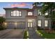 Beautiful home with a two-car garage, landscaped yard, and stone pathway leading to the front door at 15630 N Himes Ave, Tampa, FL 33618
