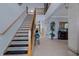 Grand foyer with a staircase, tile flooring, high ceilings, and a decorative table at 15630 N Himes Ave, Tampa, FL 33618