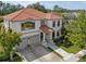 Elegant two-story home with a manicured lawn, a fountain, and a welcoming front porch at 15630 N Himes Ave, Tampa, FL 33618