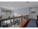 Open loft area overlooking the pool featuring a chandelier and wood and wrought iron railings at 15630 N Himes Ave, Tampa, FL 33618