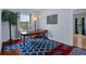 Home office with hardwood floors, decorative rug, and views of the backyard at 15630 N Himes Ave, Tampa, FL 33618