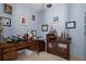 Cozy office space with a classic wooden desk, decorative display shelves, and muted blue walls at 15630 N Himes Ave, Tampa, FL 33618