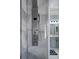 Shower stall with shower panel with various sprays, and a view into the bathroom with double vanity at 15630 N Himes Ave, Tampa, FL 33618