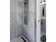 Shower stall featuring a shower panel with various sprays and bathroom with double vanity in view at 15630 N Himes Ave, Tampa, FL 33618