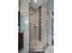 Luxurious shower featuring glass doors, modern tile, and rainfall shower head at 15630 N Himes Ave, Tampa, FL 33618