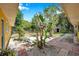 Landscaped backyard with brick pavers and lush tropical plants adding a calming and serene touch at 1665 Laura St, Clearwater, FL 33755