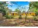 A spacious backyard of a yellow house, perfect for outdoor activities and relaxation at 1665 Laura St, Clearwater, FL 33755