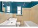 Vintage bathroom with blue accent walls and yellow tile at 1665 Laura St, Clearwater, FL 33755
