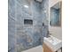 Modern shower with blue marble tile and a built-in niche at 1665 Laura St, Clearwater, FL 33755