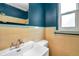 Vintage bathroom with blue accent walls and yellow tile at 1665 Laura St, Clearwater, FL 33755