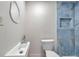 Modern half bath with vessel sink and tiled walk in shower at 1665 Laura St, Clearwater, FL 33755