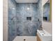 Modern shower with blue marble tile and a built-in niche at 1665 Laura St, Clearwater, FL 33755