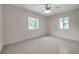 Large, airy bedroom with a ceiling fan and two windows at 1665 Laura St, Clearwater, FL 33755
