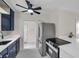 Modern kitchen with stainless steel appliances, dark cabinets, and a stylish ceiling fan at 1665 Laura St, Clearwater, FL 33755