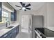 Updated kitchen featuring stainless steel appliances, dark cabinets, and a view to the dining area at 1665 Laura St, Clearwater, FL 33755