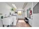 Well-lit laundry room featuring a washing machine, sink, shelving, and ample storage at 1665 Laura St, Clearwater, FL 33755