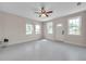 Sunlit living room with white walls, ceiling fan, and view to front yard at 1665 Laura St, Clearwater, FL 33755