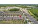 A high angle view of a neighborhood, with houses, trees and a pond at 16930 Red Brick Ln, Land O Lakes, FL 34638