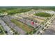 Overhead view of homes in a community, surrounded by trees and well manicured lawns at 16930 Red Brick Ln, Land O Lakes, FL 34638