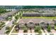 Aerial view of multi-Gathering homes with well-maintained landscaping and a pond in the distance at 16930 Red Brick Ln, Land O Lakes, FL 34638