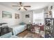 A simple, sunny bedroom with a single bed, writing desk, and minimalist décor at 16930 Red Brick Ln, Land O Lakes, FL 34638