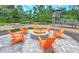 Gather around the cozy fire pit with Adirondack chairs, creating a perfect outdoor gathering space at 16930 Red Brick Ln, Land O Lakes, FL 34638