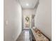 Bright foyer with neutral walls, tiled floor, decorative wreath on the glass front door, and stairway access at 16930 Red Brick Ln, Land O Lakes, FL 34638