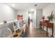 The neutrally decorated hallway has elegant, artful touches with hardwood floors at 16930 Red Brick Ln, Land O Lakes, FL 34638