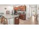 Modern kitchen featuring dark wood cabinets, granite countertops, stainless steel appliances, and a breakfast bar at 16930 Red Brick Ln, Land O Lakes, FL 34638