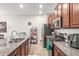 Well-lit kitchen featuring granite countertops, stainless steel appliances, modern cabinets, and tile flooring at 16930 Red Brick Ln, Land O Lakes, FL 34638