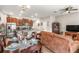 A spacious living room features an open kitchen, comfortable seating, and warm, inviting decor at 16930 Red Brick Ln, Land O Lakes, FL 34638